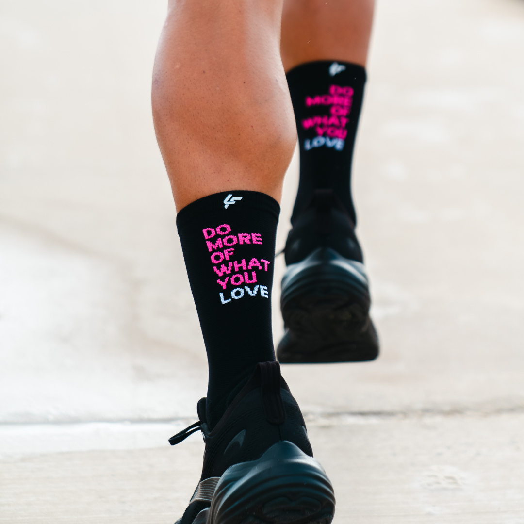 Image of person wearing Lightfeet Performance Do More Of What You Love Black Pink White Crew Socks
