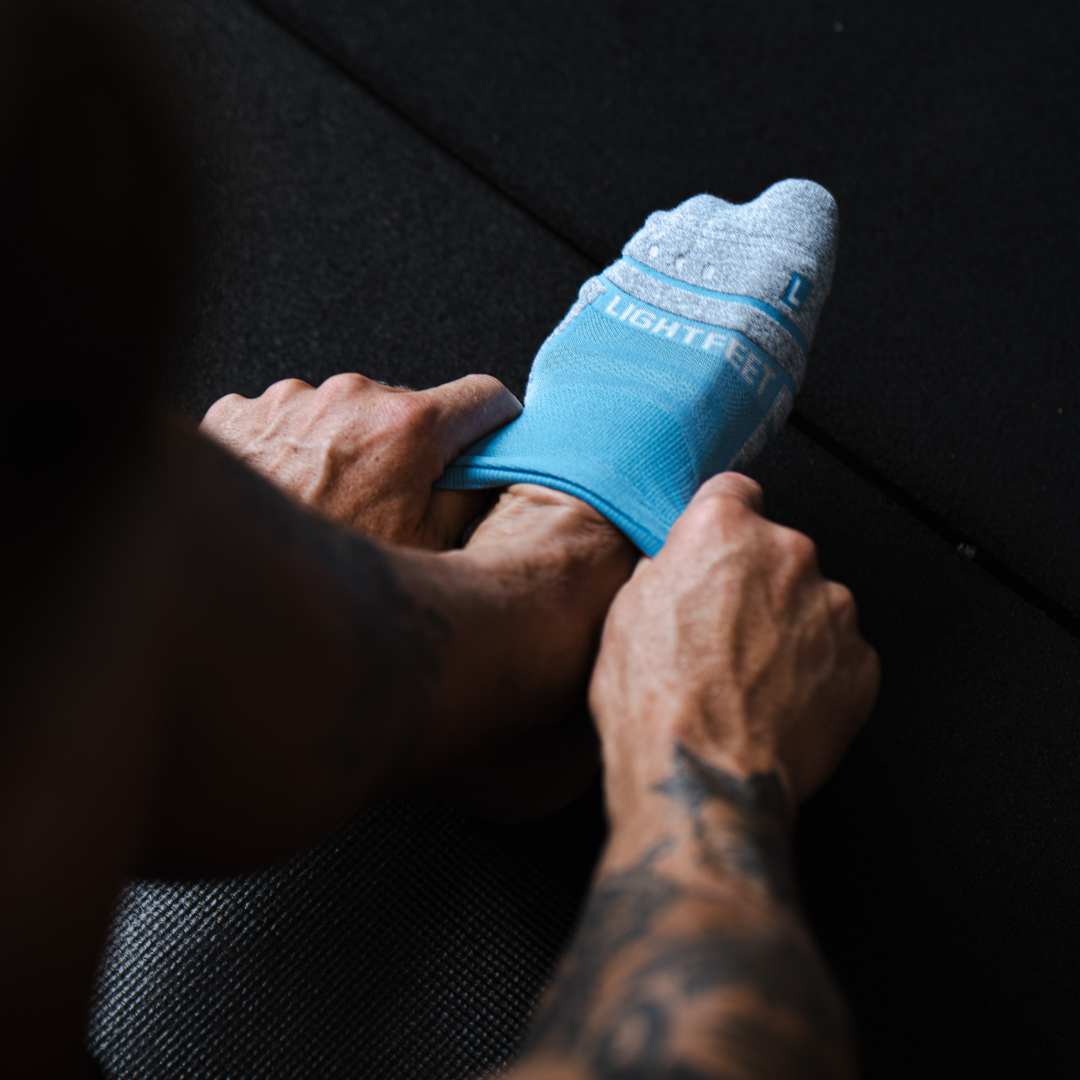Person wearing Lightfeet Performance Soft Blue Ankle Sock