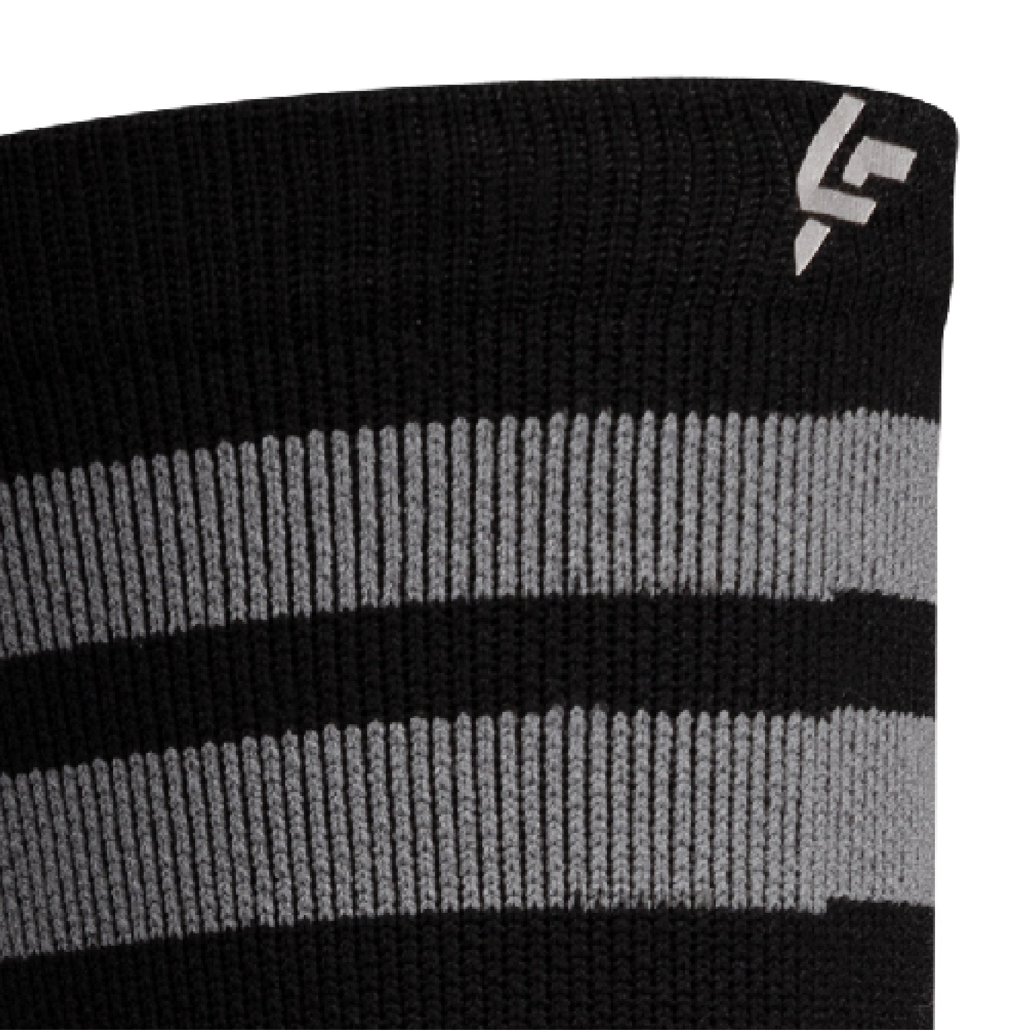 Close up view of reflective print symbol on Lightfeet Performance 2 Stripes Black Half Crew Sock