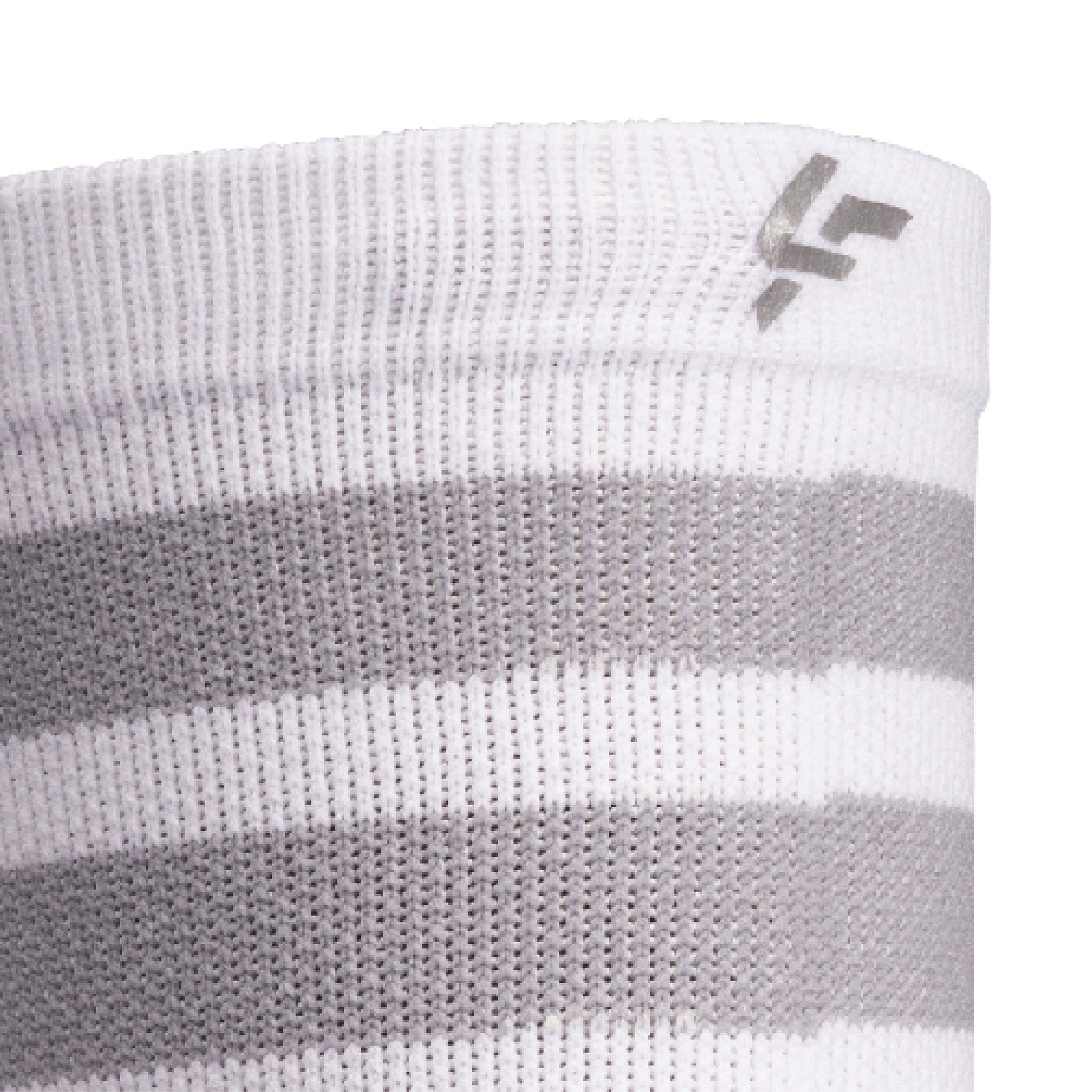 Close up view of reflective print symbol on Lightfeet Performance 2 Stripes White Half Crew Sock