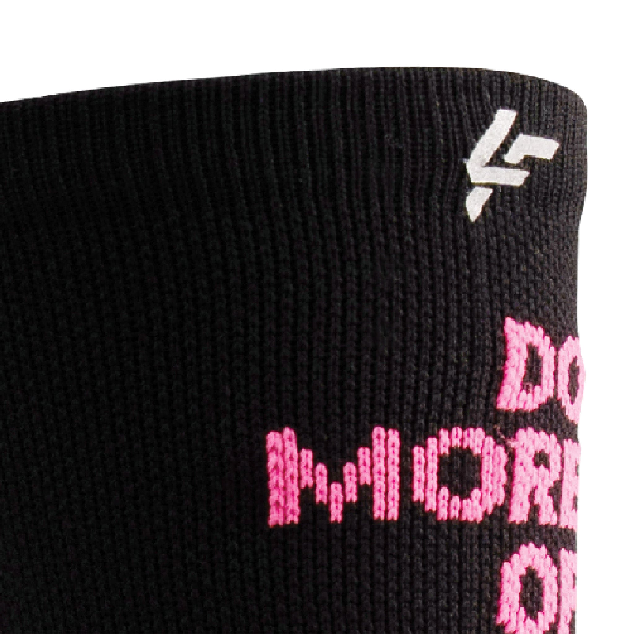 Close up view of reflective print symbol on Lightfeet Performance Do More Of What You Love Black Pink White Crew Socks
