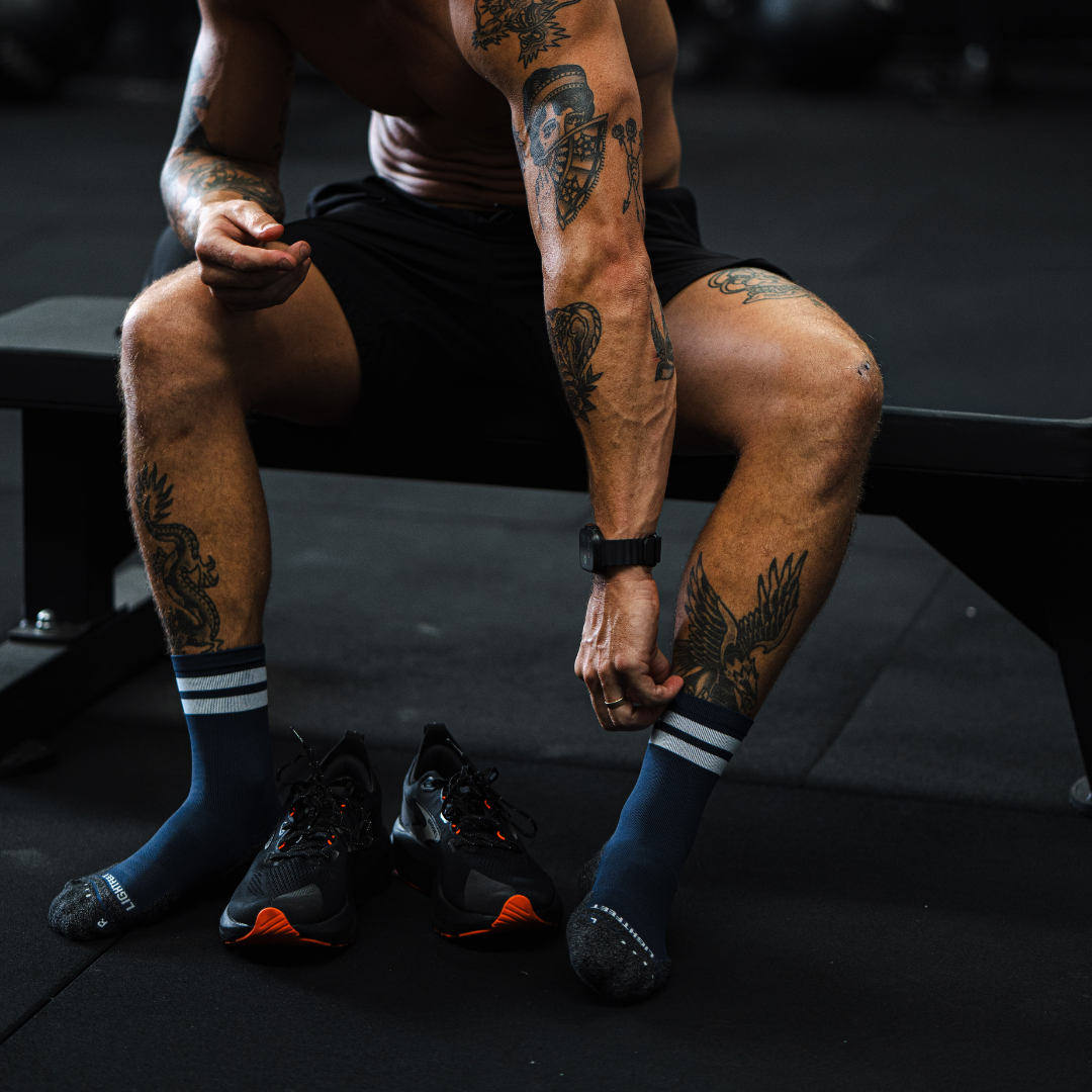 Image of person wearing Lightfeet Performance 2 Stripes Navy Half Crew Socks
