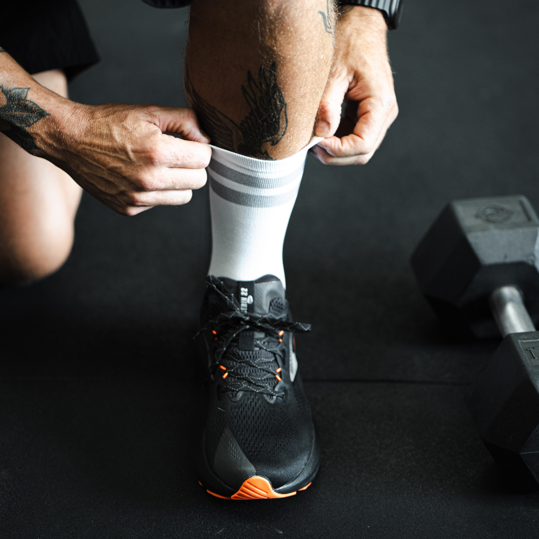 Image of person wearing Lightfeet Performance 2 Stripes White Half Crew Socks