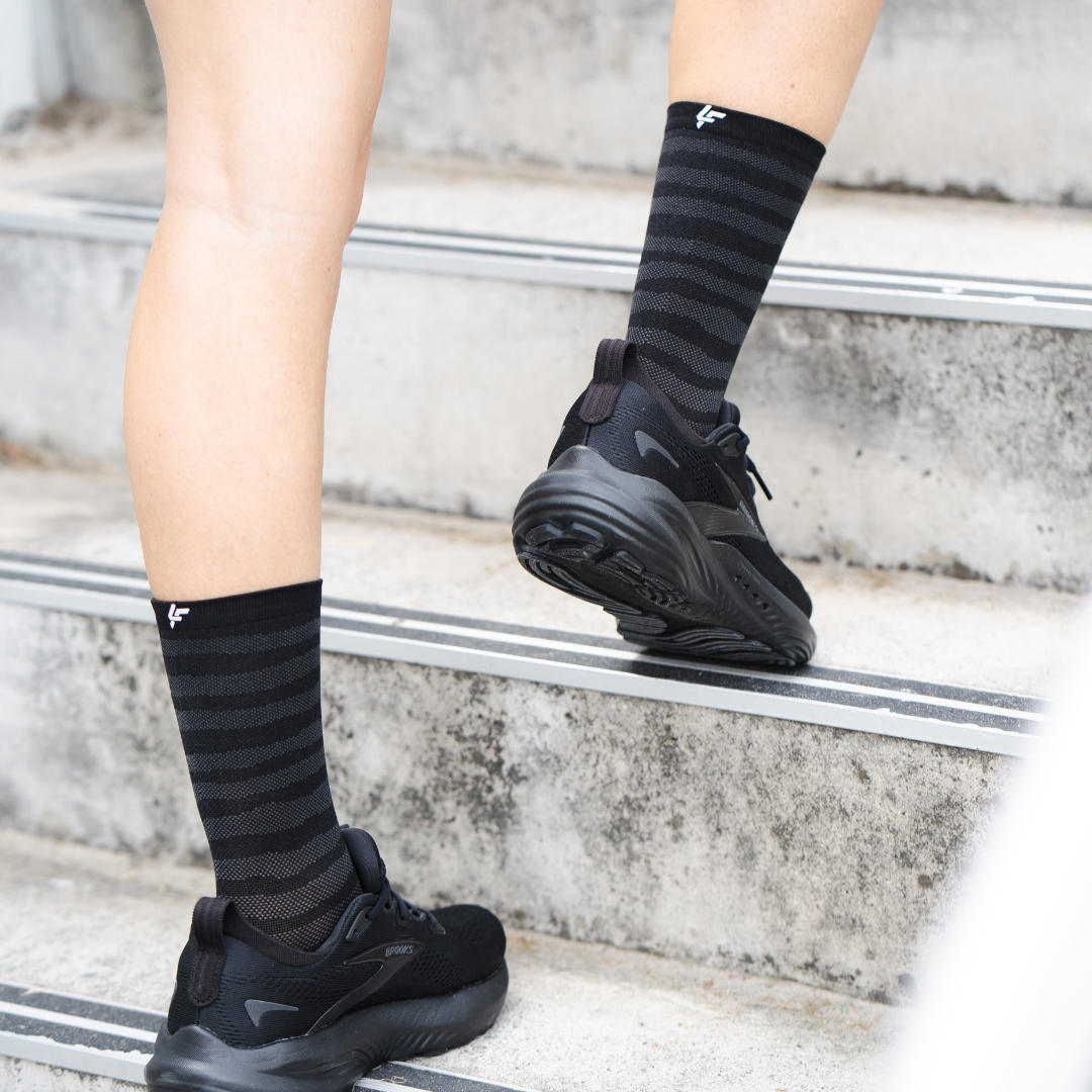 Image of person wearing Lightfeet Performance Raster Black Half Crew Socks
