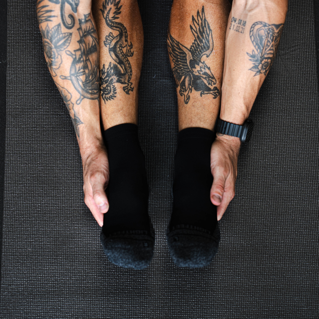 Person wearing Lightfeet Performance Black Quarter Crew Socks