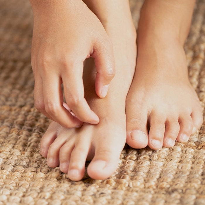 Person lightly scratching foot