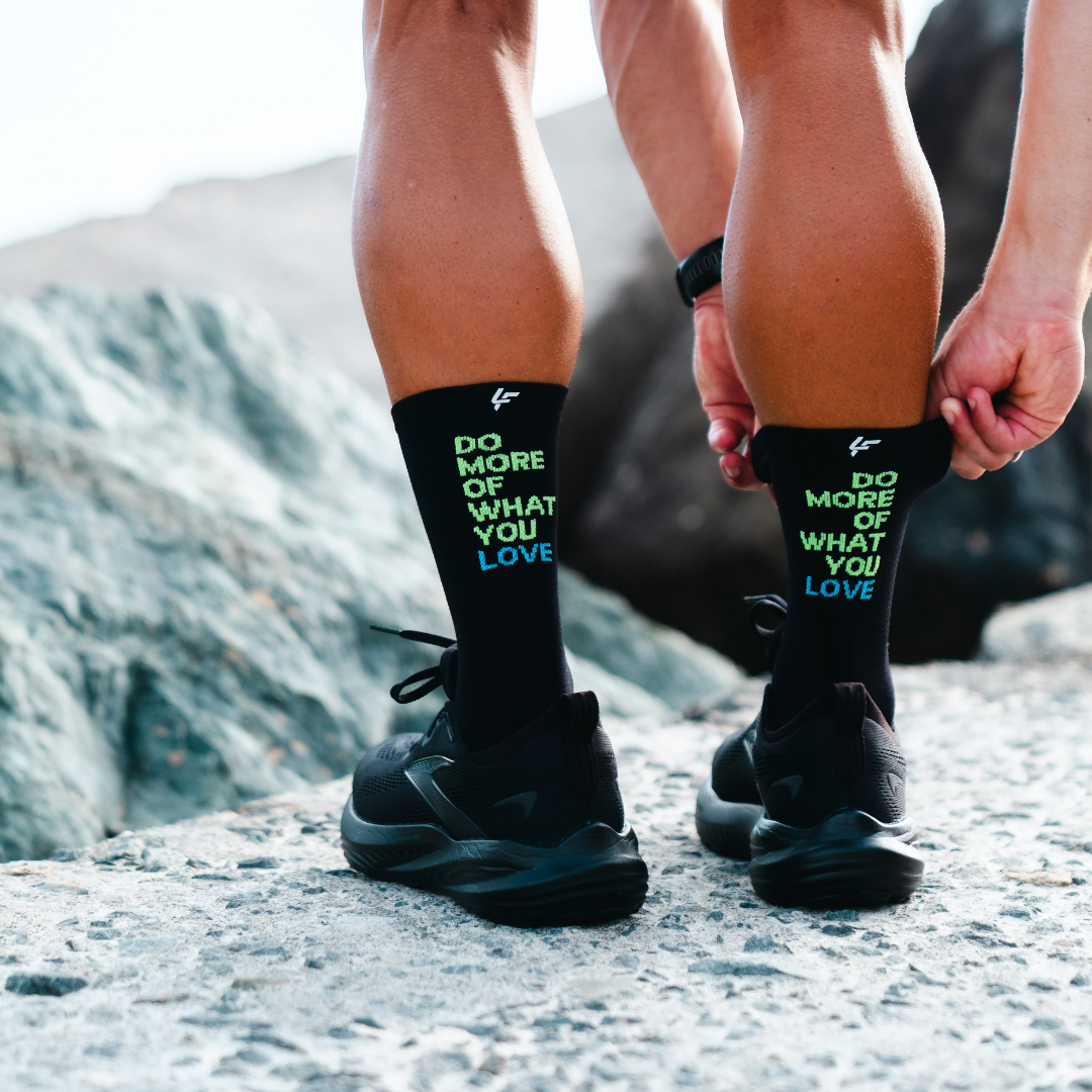 Image of person wearing Lightfeet Performance Do More Of What You Love Black Yellow Aqua Crew Socks 