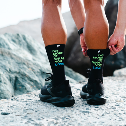 Image of person wearing Lightfeet Performance Do More Of What You Love Black Yellow Aqua Crew Socks 