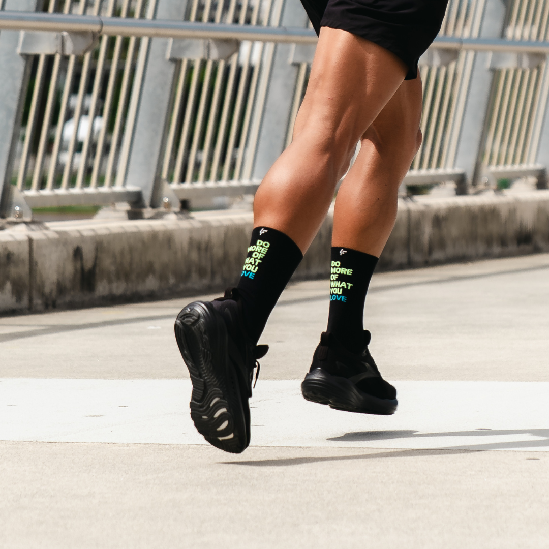 Image of person wearing Lightfeet Performance Do More Of What You Love Black Yellow Aqua Crew Socks 