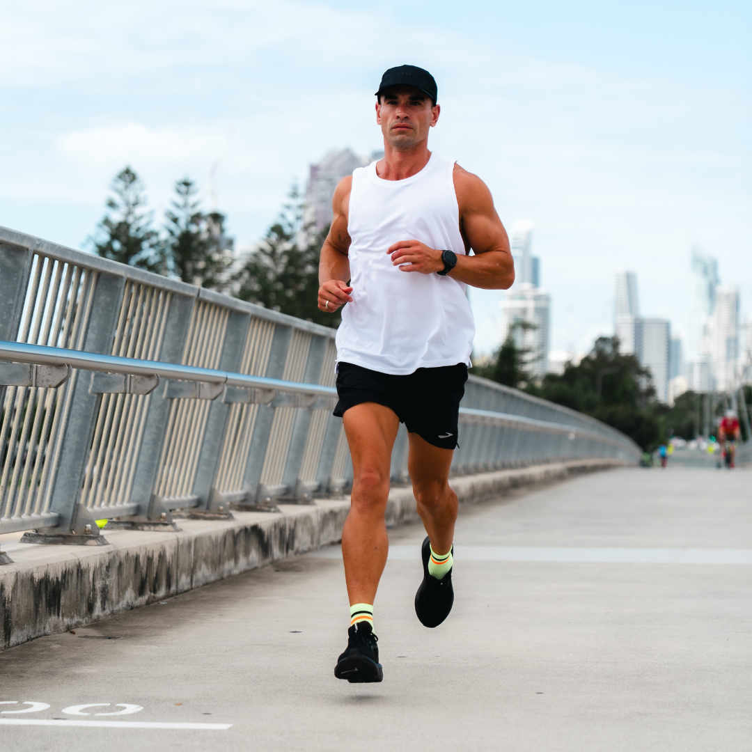 Image of person wearing Lightfeet Performance 2 Stripes Yellow Black Orange Quarter Socks 