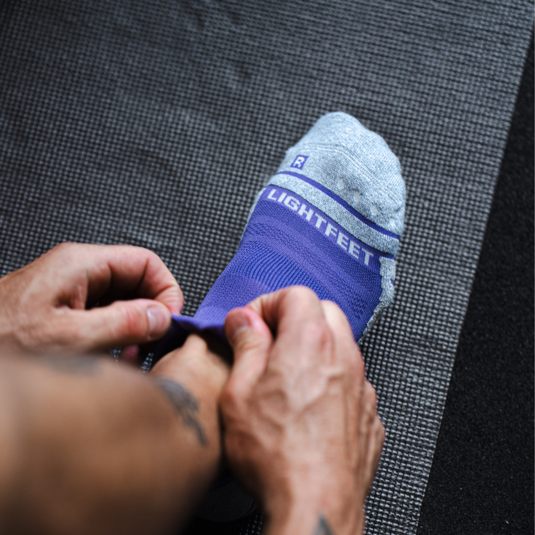 Person wearing Lightfeet Performance Violet Ankle Sock 