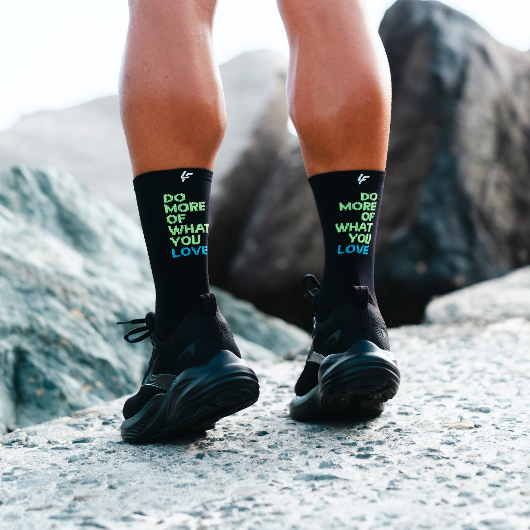 Image of person wearing Lightfeet Performance Do More Of What You Love Black Yellow Aqua Crew Socks 