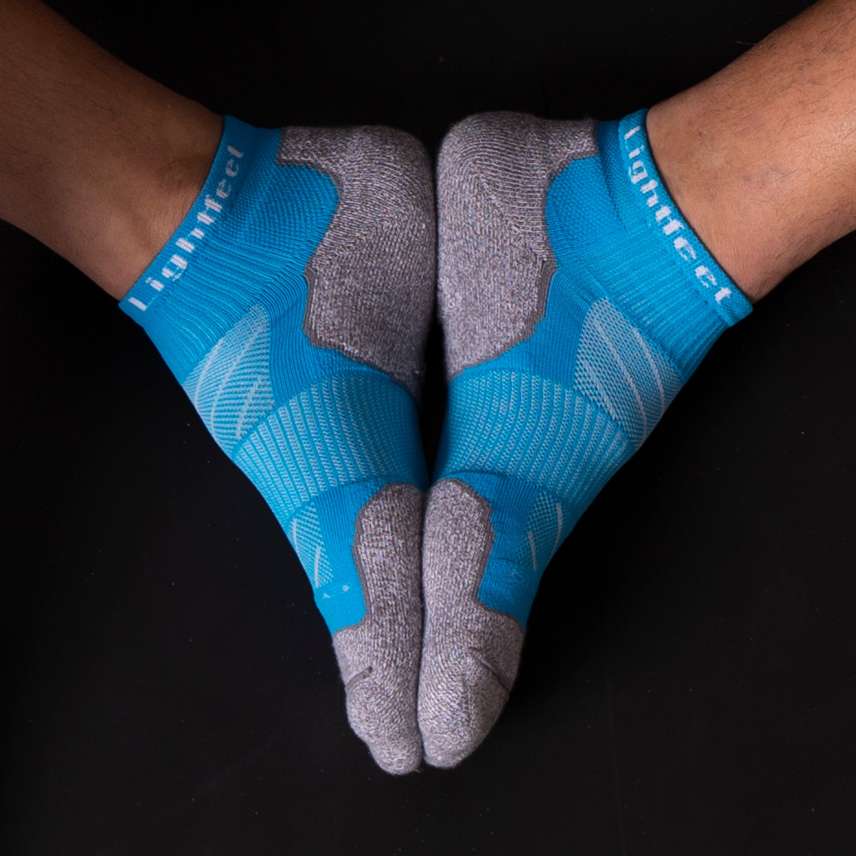 Pair of Lightfeet Evolution Aqua Mini Crew socks on foot