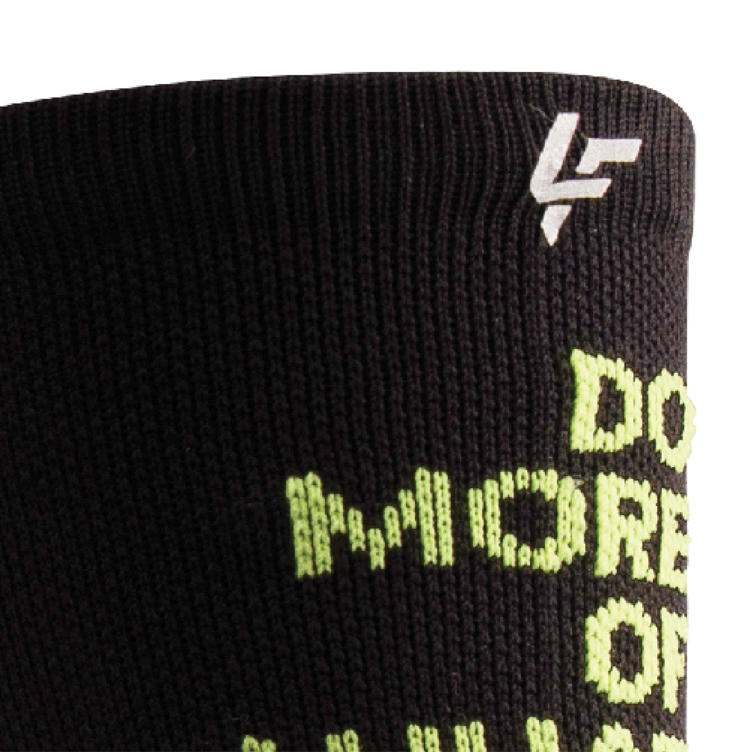 Close up view of reflective print symbol on Lightfeet Performance Do More Of What You Love Black Yellow Aqua Crew Socks 