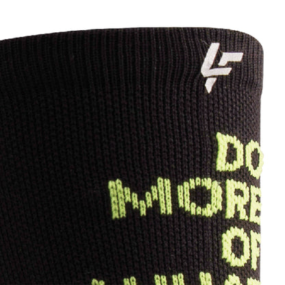 Close up view of reflective print symbol on Lightfeet Performance Do More Of What You Love Black Yellow Aqua Crew Socks 