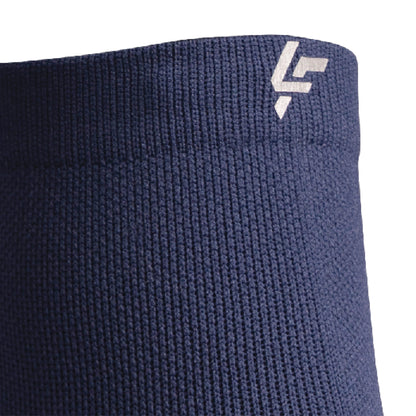 Close up view of reflective symbol on Lightfeet Performance Navy Quarter Crew Sock 