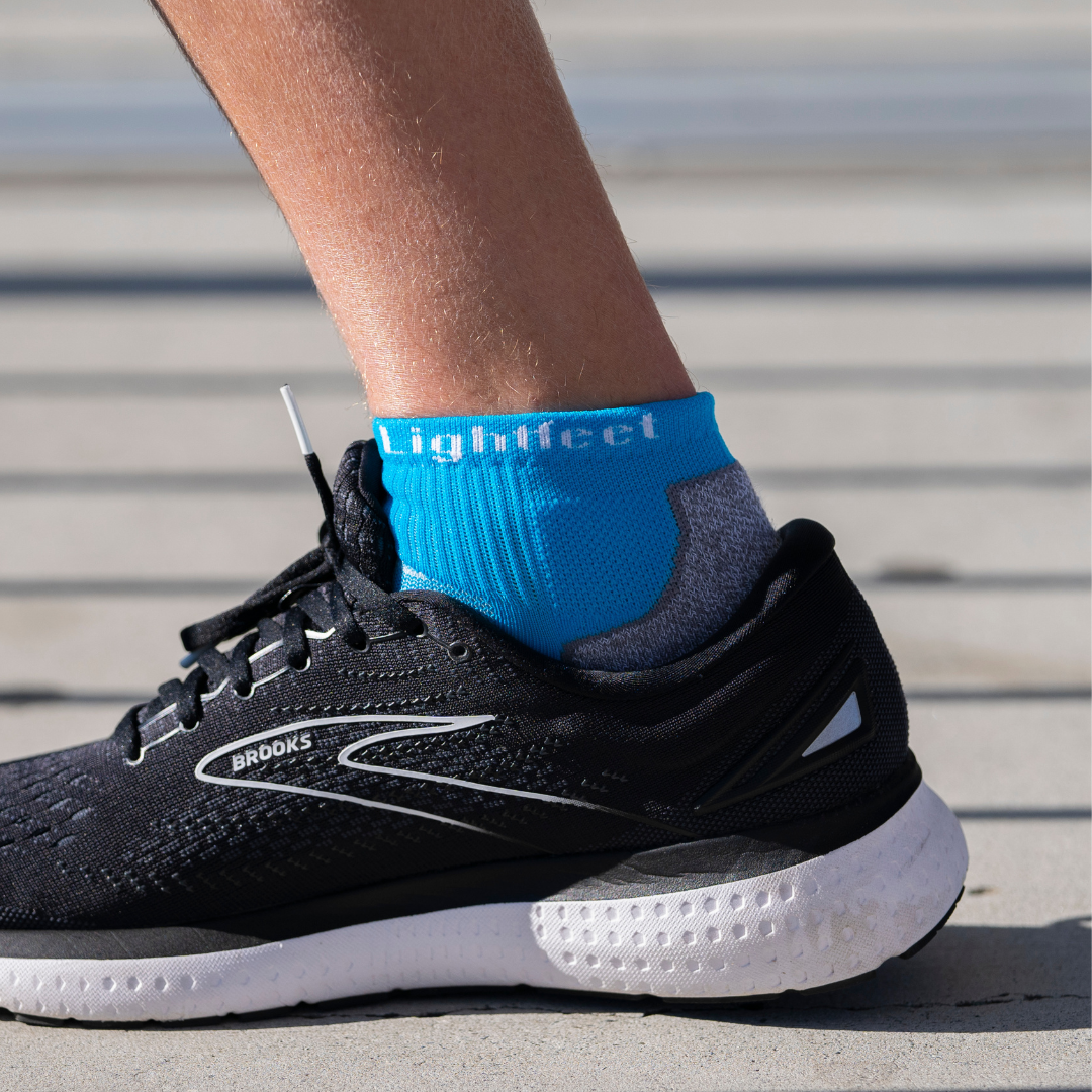 Person wearing Lightfeet Evolution Aqua Mini Crew Socks 