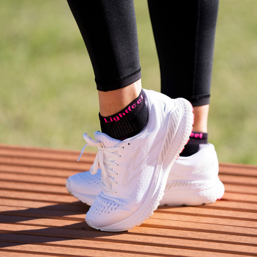 Person wearing Lightfeet Evolution Black Fluro Pink Mini Crew Socks 