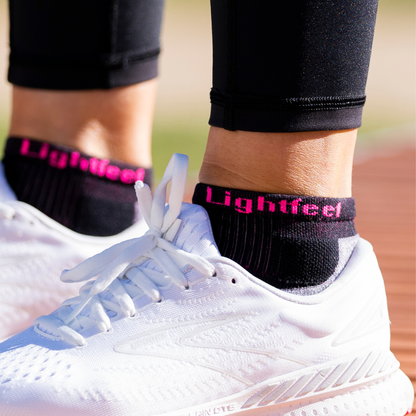 Person wearing Lightfeet Evolution Black Fluro Pink Mini Crew Socks 