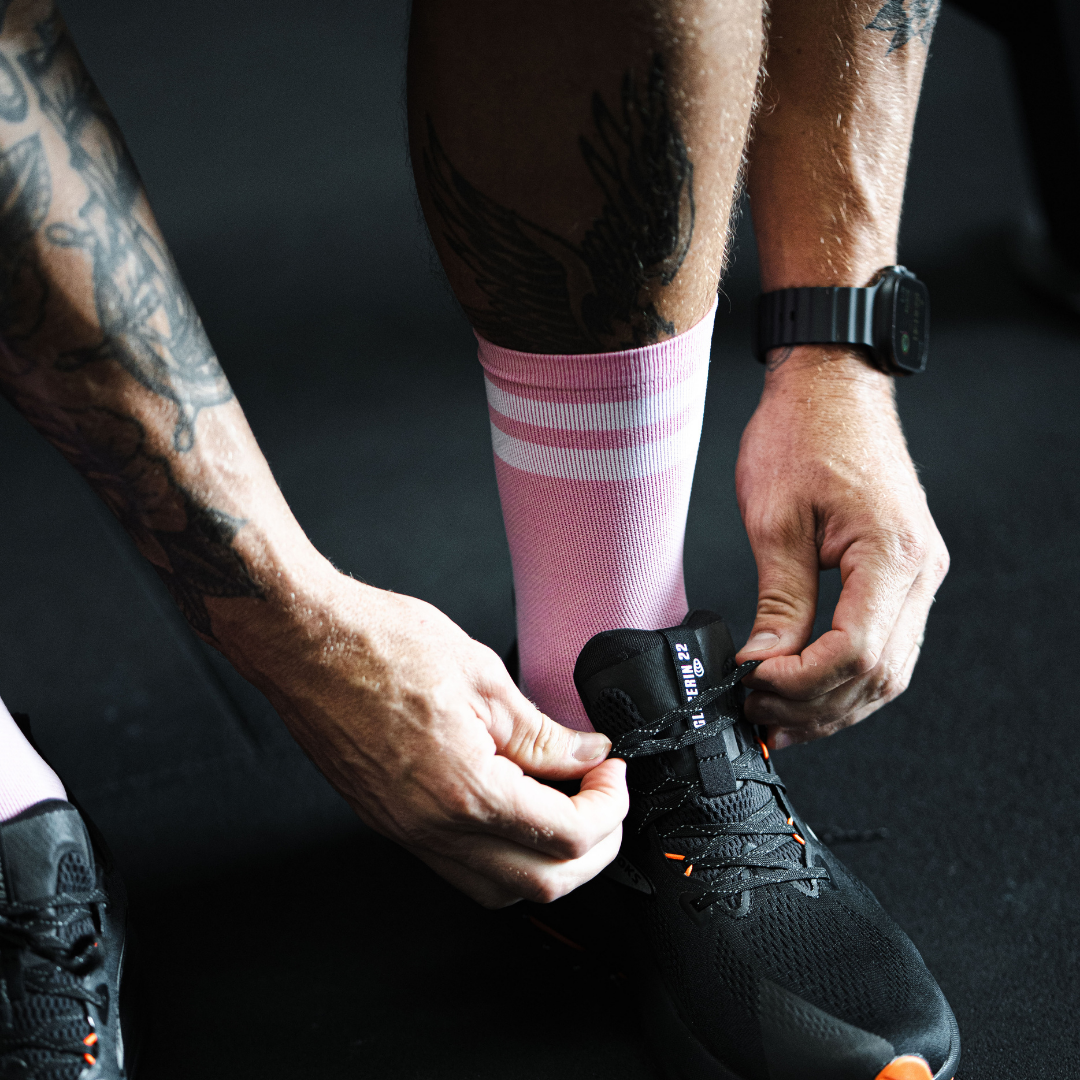 Image of person wearing Lightfeet Performance 2 Stripes Soft Pink Half Crew Socks 