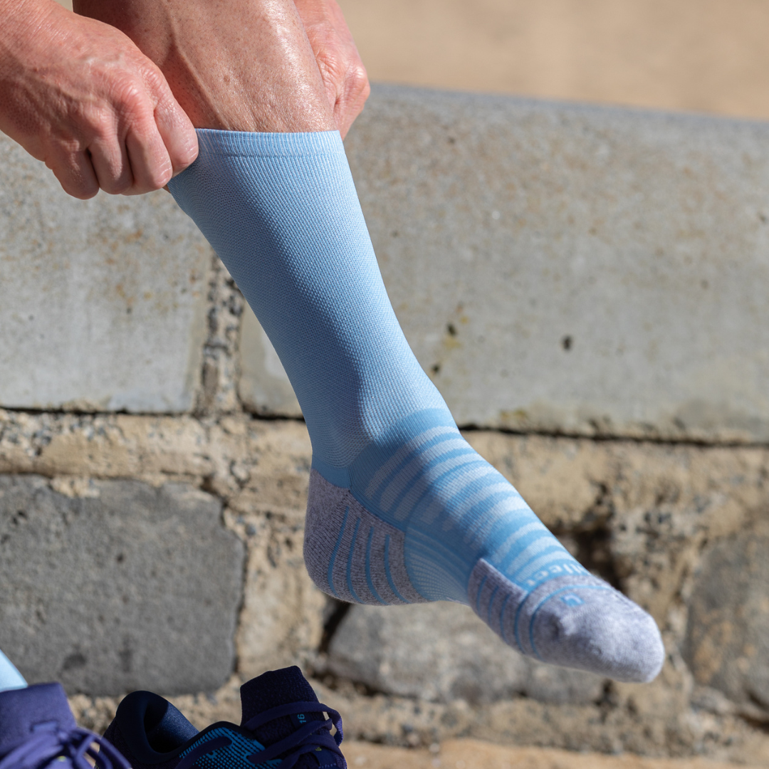Person wearing Lightfeet Performance Soft Blue Half Crew Sock 