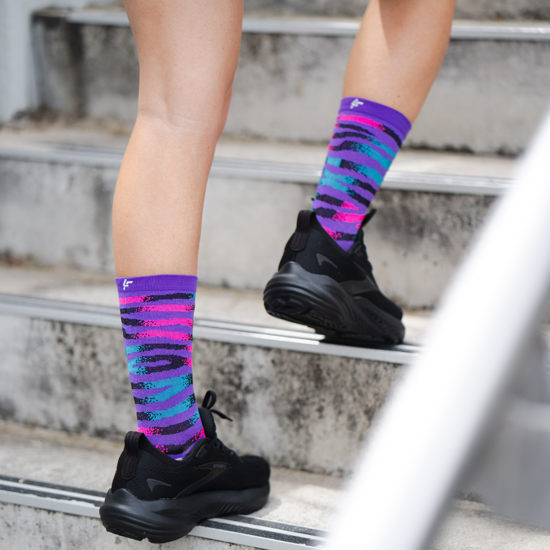 Image of person wearing Lightfeet Performance Predator Purple Aqua Pink Half Crew Socks 