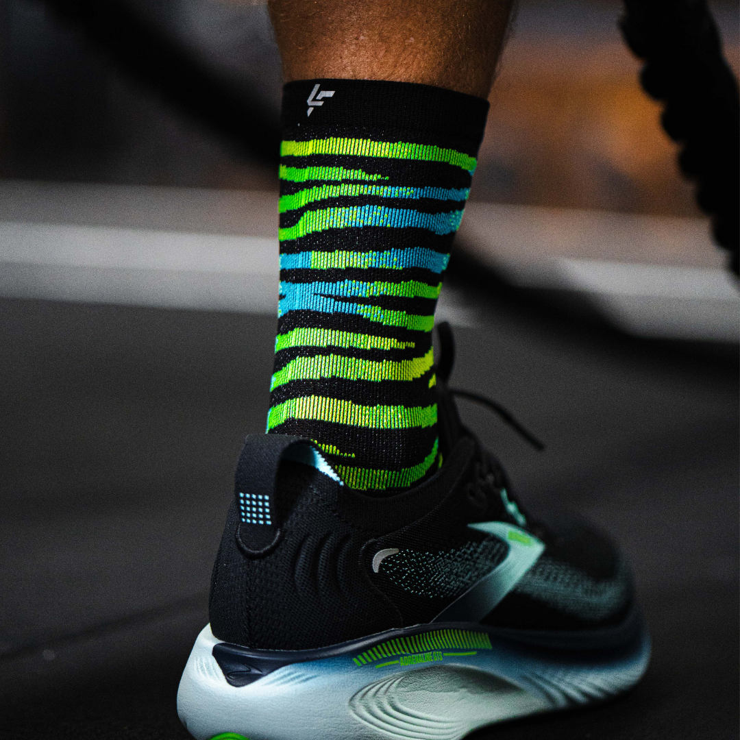 Image of person wearing Lightfeet Performance Predator Black Yellow Aqua Half Crew Sock 