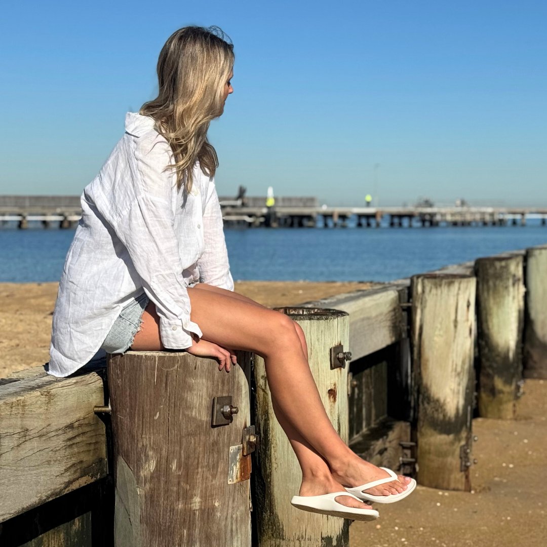 Person wearing White Lightfeet Arch Support Thongs