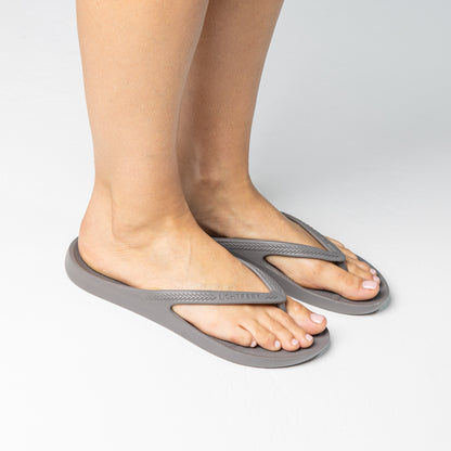 Person walking on and off screen wearing Coastal Grey Lightfeet Arch Support Thongs