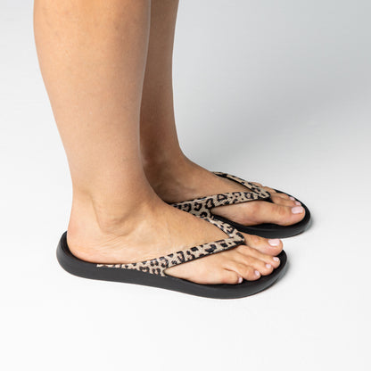 Person walking on and off screen wearing Black Leopard Lightfeet Arch Support Thongs